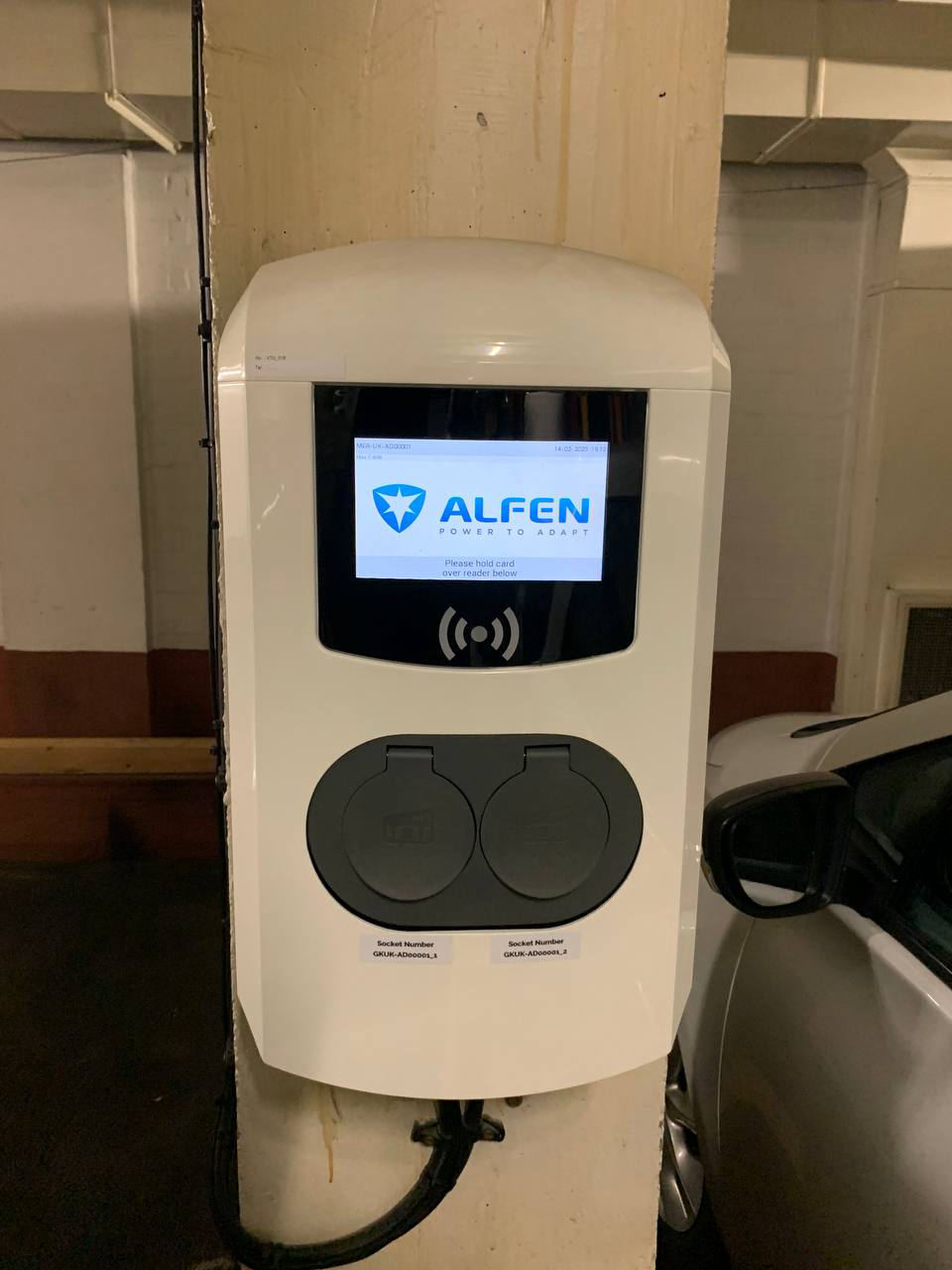 Alfen dual-socket EV charge point mounted on a concrete column in an underground car park
