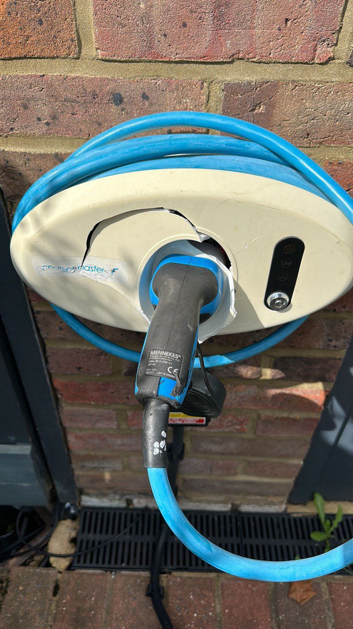 The same charge point back in service after repair, with a tethered cable fitted in place of the socket