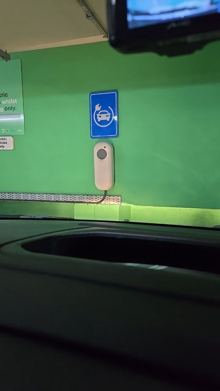 Pod Point wall-mounted home charge point in a car park