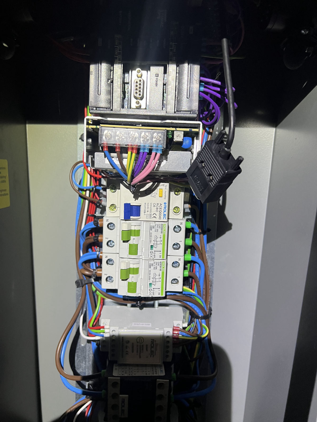 Inside a Rolec EV charge point: DIN rail with an Omron SYSMAC CP1E PLC, Rolec Mode 3 controller, RCBOs and contactor